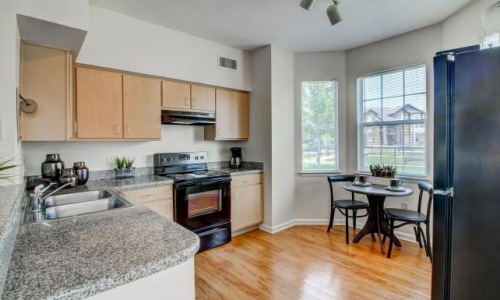 a kitchen with a table and chairs