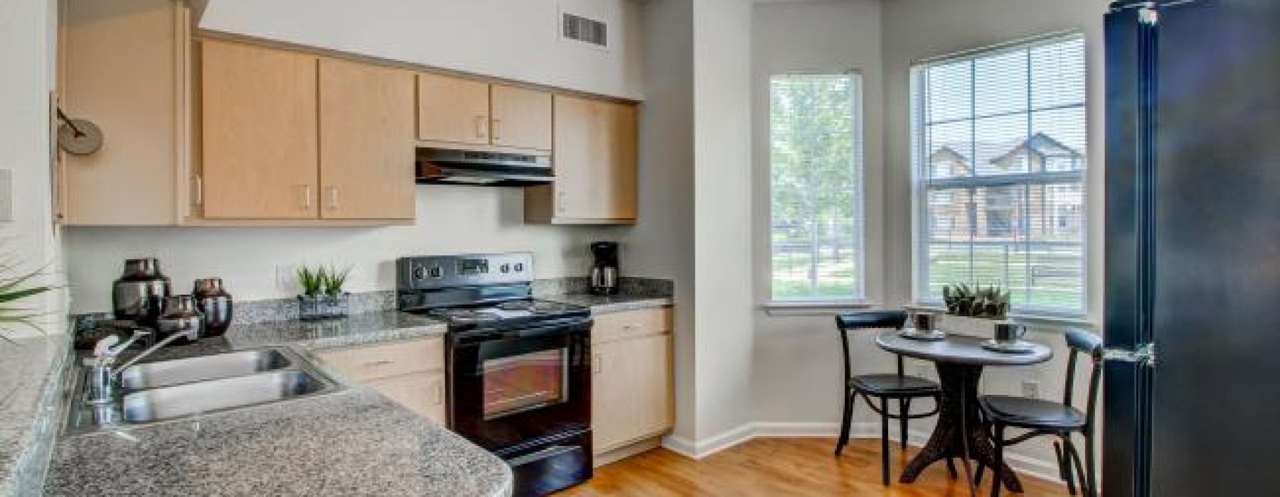 a kitchen with a table and chairs