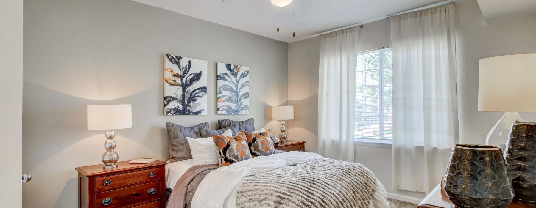 a bedroom with a bed and lamps